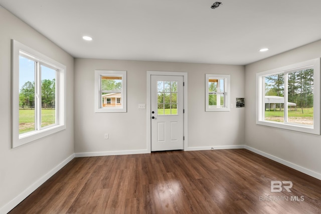 foyer entrance featuring baseboards, recessed lighting, and dark wood-style floors