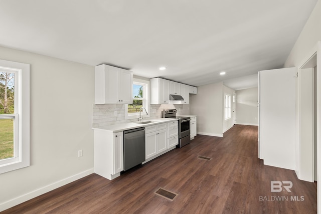 kitchen featuring light countertops, visible vents, tasteful backsplash, appliances with stainless steel finishes, and a sink