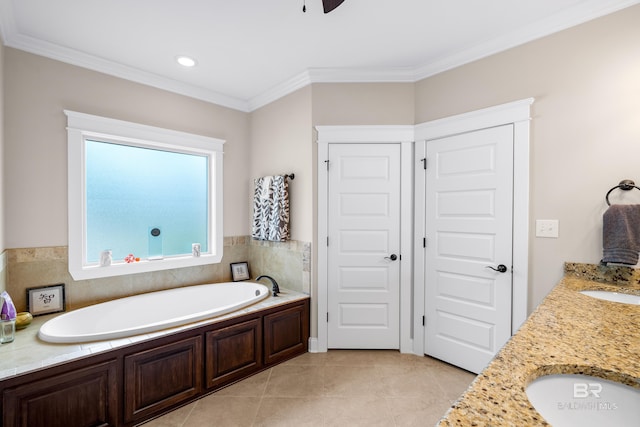 bathroom with ceiling fan, a tub to relax in, tile patterned floors, crown molding, and vanity