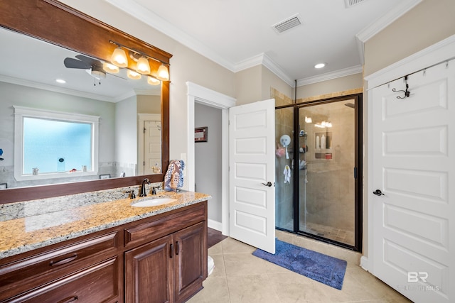 bathroom featuring ceiling fan, tile patterned flooring, crown molding, a shower with door, and vanity