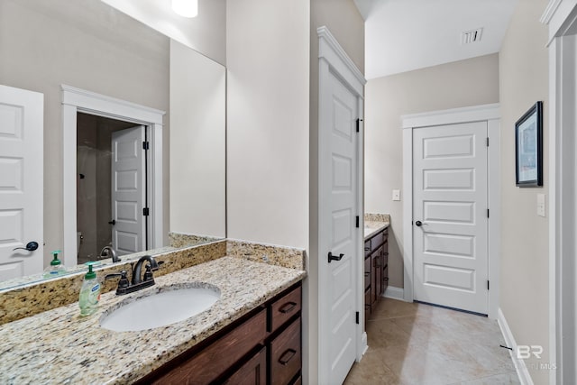 bathroom with tile patterned flooring and vanity