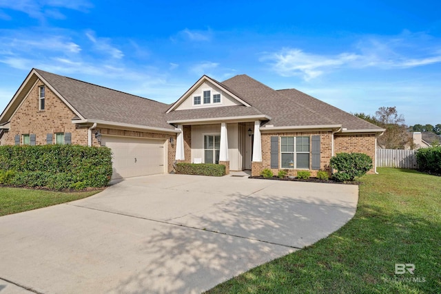 craftsman-style home with a garage and a front lawn