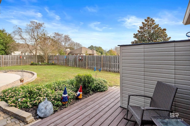 wooden deck featuring a lawn