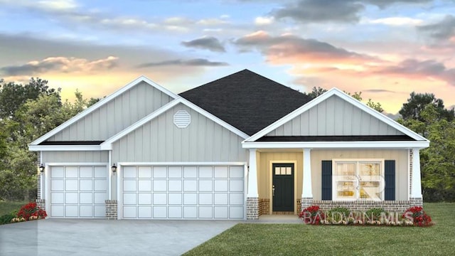 view of front of property with a garage and a yard