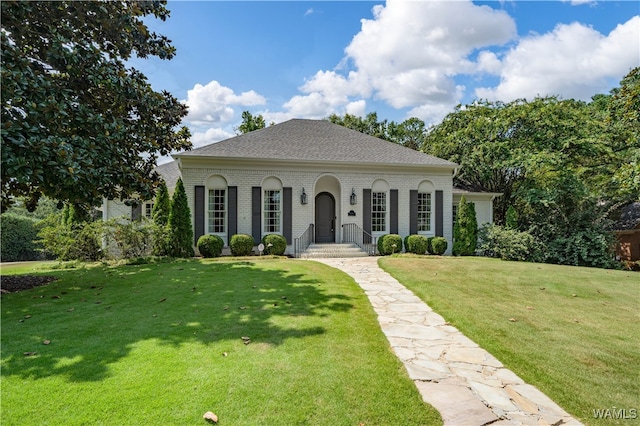 mediterranean / spanish house featuring a front yard