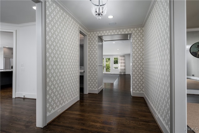 hallway featuring a chandelier, dark hardwood / wood-style flooring, and crown molding