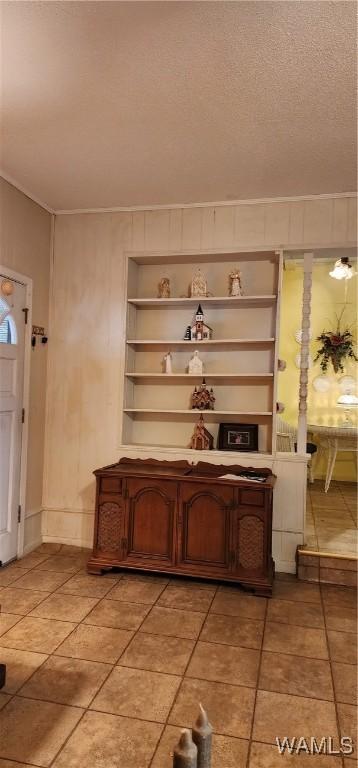 interior space with built in shelves and a textured ceiling