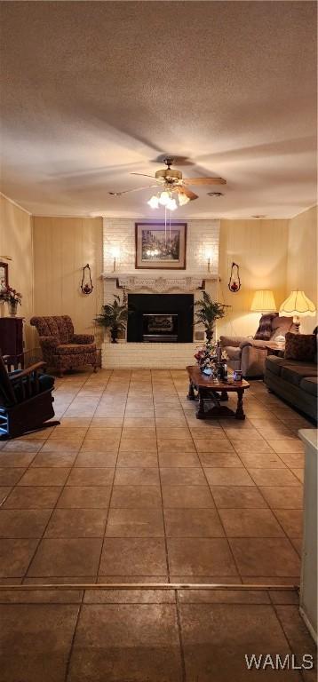 living room with a textured ceiling and ceiling fan