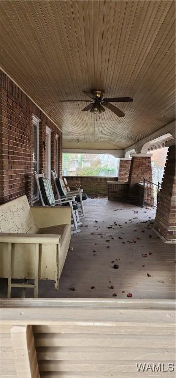 deck with ceiling fan and covered porch