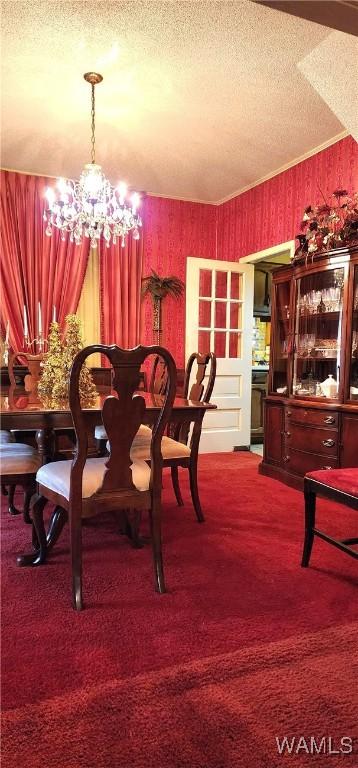 dining space with carpet flooring, a textured ceiling, and a chandelier