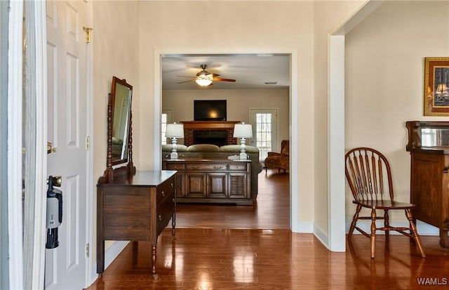 17174 Finnell Rd, Northport, AL 35475 - foyer featuring dark wood finished floors, a brick fireplace, baseboards, and ceiling fan