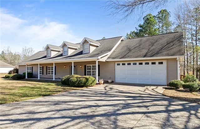 17174 Finnell Rd, Northport, AL 35475 - cape cod home featuring a front lawn, a porch, concrete driveway, and a garage