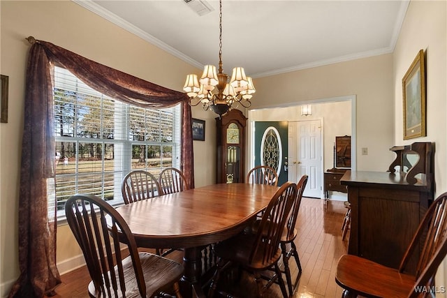 17174 Finnell Rd, Northport, AL 35475 - dining room featuring dark wood finished floors, crown molding, a notable chandelier, and visible vents
