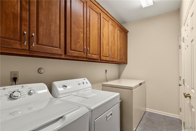 17174 Finnell Rd, Northport, AL 35475 - clothes washing area with tile patterned floors, baseboards, cabinet space, and separate washer and dryer