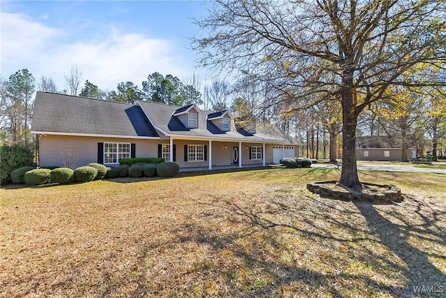 17174 Finnell Rd, Northport, AL 35475 - cape cod house with covered porch, an attached garage, and a front lawn