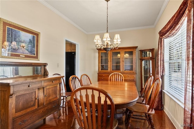 17174 Finnell Rd, Northport, AL 35475 - dining space with an inviting chandelier, dark wood-style floors, ornamental molding, and a healthy amount of sunlight