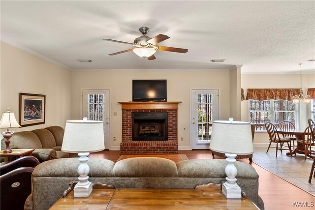 17174 Finnell Rd, Northport, AL 35475 - living area with a brick fireplace, ornamental molding, baseboards, and ceiling fan
