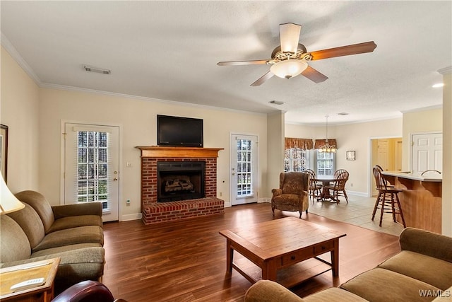 17174 Finnell Rd, Northport, AL 35475 - living room featuring ceiling fan, visible vents, wood finished floors, and crown molding