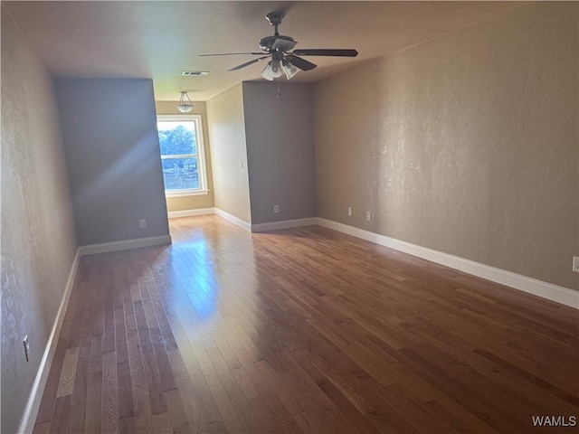 10617 Austin Loop, Vance, AL 35490 - empty room featuring dark wood-style floors, a ceiling fan, and a textured wall