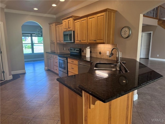 10617 Austin Loop, Vance, AL 35490 - kitchen featuring stainless steel appliances, tasteful backsplash, a breakfast bar area, a peninsula, and crown molding