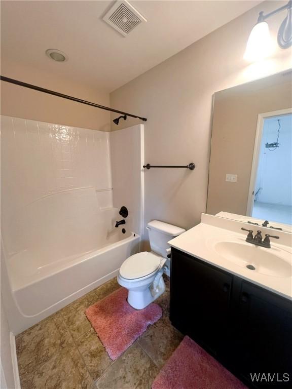 11507 Belle Meade Ave, Northport, AL 35475 - bathroom featuring vanity, tub / shower combination, and toilet