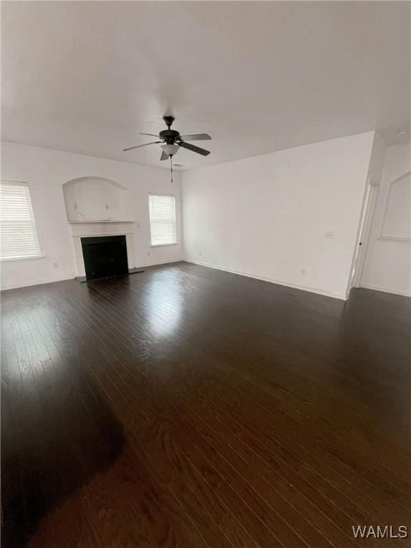 11507 Belle Meade Ave, Northport, AL 35475 - unfurnished living room featuring ceiling fan, dark wood-style floors, and a fireplace