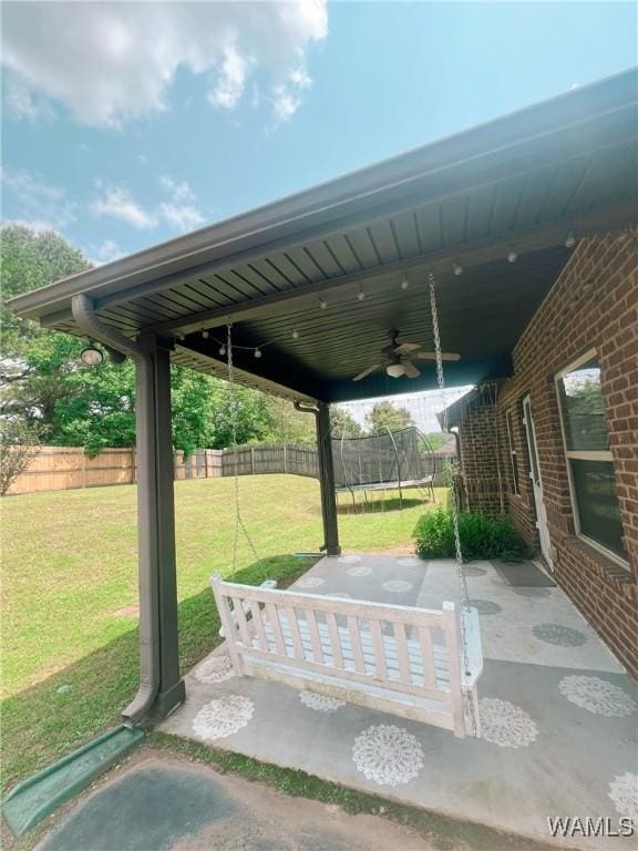 11507 Belle Meade Ave, Northport, AL 35475 - view of patio with a ceiling fan and a trampoline