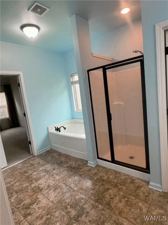 11507 Belle Meade Ave, Northport, AL 35475 - bathroom with a garden tub, a stall shower, baseboards, and healthy amount of natural light