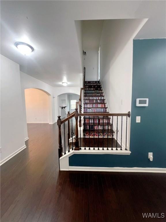 11507 Belle Meade Ave, Northport, AL 35475 - staircase with arched walkways, wood finished floors, and baseboards