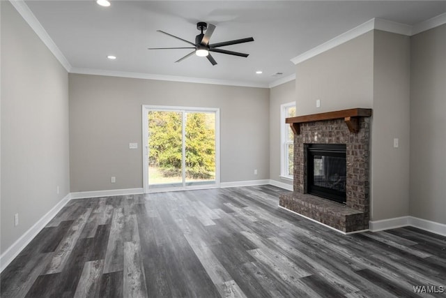 unfurnished living room featuring a brick fireplace, ceiling fan, dark hardwood / wood-style floors, and ornamental molding