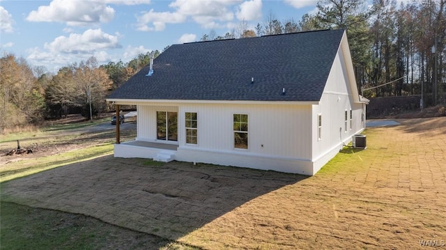 rear view of house featuring cooling unit