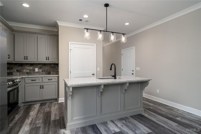 kitchen with dark hardwood / wood-style flooring, sink, a center island with sink, and electric stove