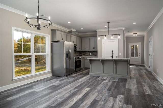 kitchen with pendant lighting, a center island with sink, dark hardwood / wood-style floors, gray cabinets, and appliances with stainless steel finishes