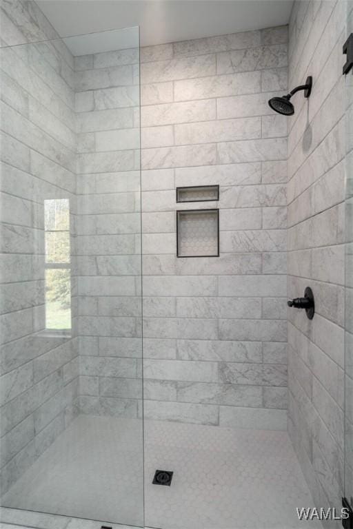 bathroom featuring a shower with door