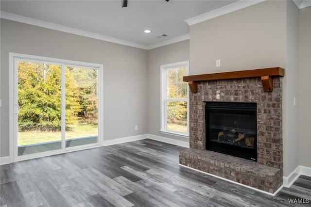 unfurnished living room with hardwood / wood-style floors, crown molding, and a wealth of natural light