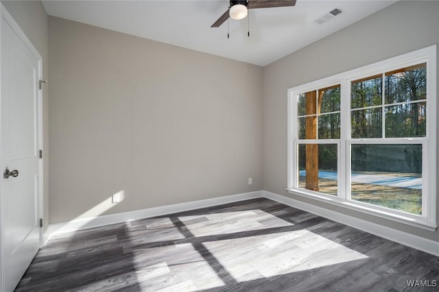 spare room featuring ceiling fan and dark hardwood / wood-style flooring