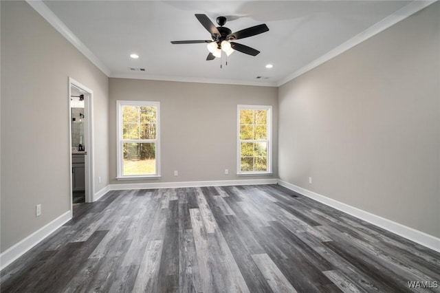 unfurnished room with a wealth of natural light, dark hardwood / wood-style floors, and ornamental molding
