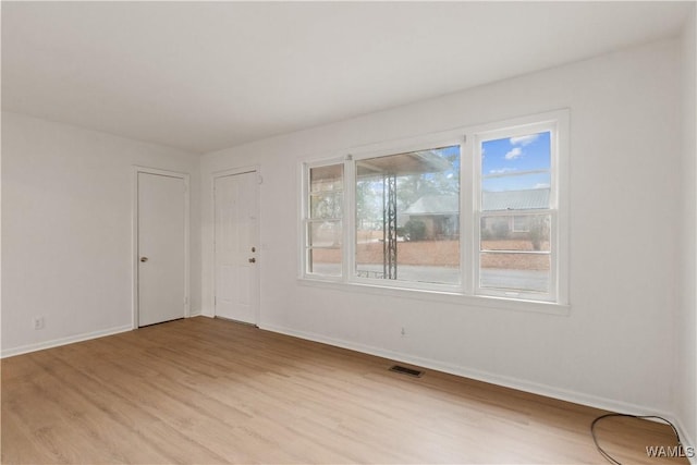 unfurnished room featuring light wood-type flooring