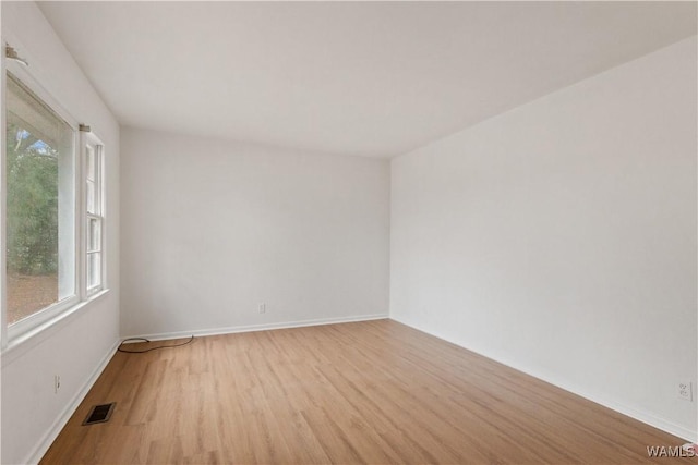 spare room featuring light hardwood / wood-style flooring