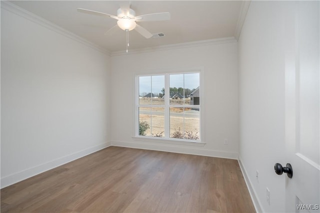 spare room with ornamental molding, ceiling fan, and light wood-type flooring