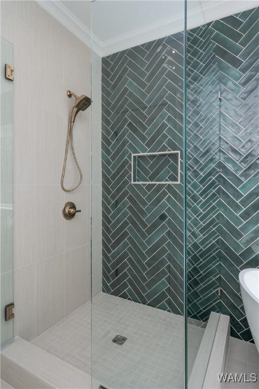 bathroom featuring crown molding and shower with separate bathtub