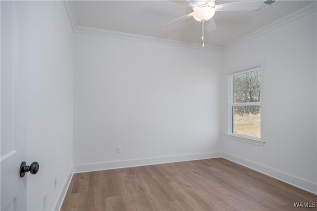 unfurnished room featuring ornamental molding, ceiling fan, and light wood-type flooring