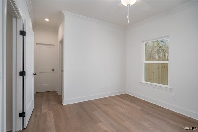 spare room with crown molding, light hardwood / wood-style floors, and ceiling fan