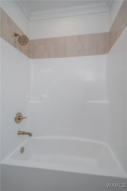 bathroom with crown molding and shower / bath combination