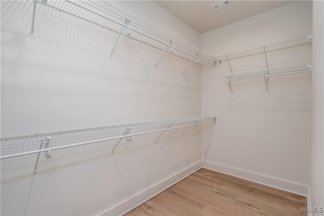 spacious closet featuring hardwood / wood-style floors