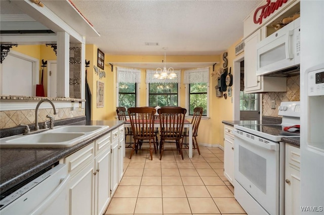 12569 Covered Bridge Rd, Brookwood, AL 35444 - kitchen featuring white appliances, tasteful backsplash, dark countertops, and a textured ceiling