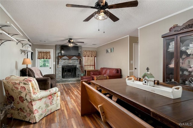 12569 Covered Bridge Rd, Brookwood, AL 35444 - living room with wood finished floors, a ceiling fan, ornamental molding, a textured ceiling, and a fireplace
