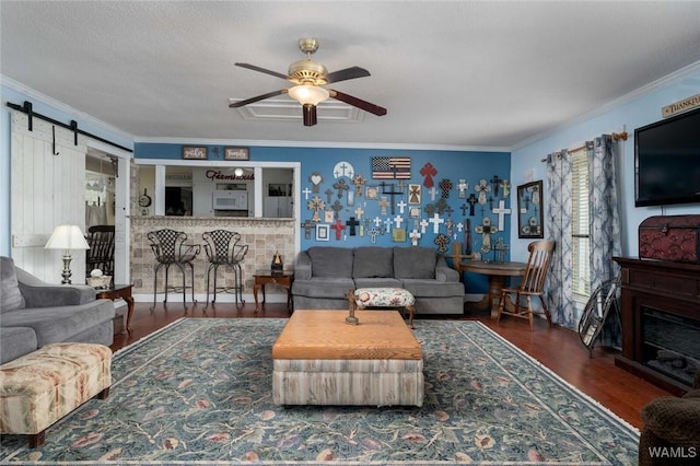 12569 Covered Bridge Rd, Brookwood, AL 35444 - living room featuring crown molding, ceiling fan, wood finished floors, and a barn door