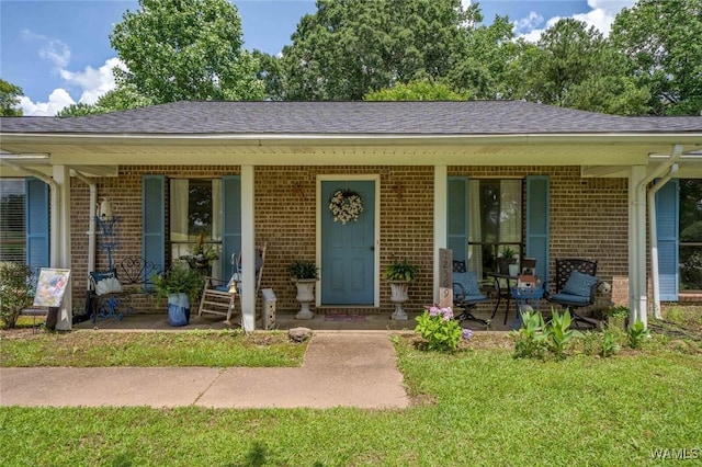 12569 Covered Bridge Rd, Brookwood, AL 35444 - view of front of home featuring a porch, brick siding, a shingled roof, and a front lawn