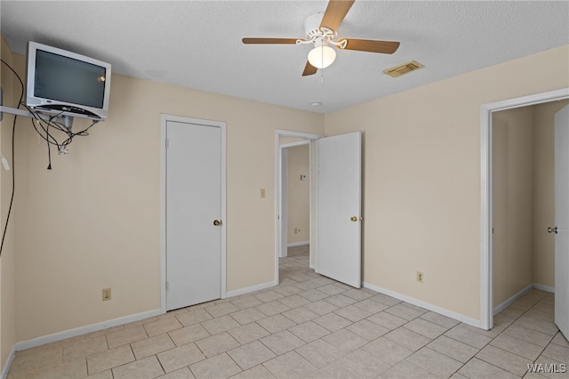 1500 W Beach Blvd Unit 212, Gulf Shores, AL 36542 - unfurnished bedroom featuring baseboards, visible vents, a textured ceiling, and ceiling fan